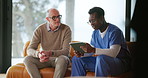 Nurse, mature man and discussion with tablet on sofa for healthcare, communication or consultation in home. Caregiver, advice and talking to senior person for help, support and medical results