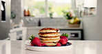 Strawberry, breakfast and pancakes on table in kitchen of home for blueberry, nutrition and health. Fruit, food and dessert or brunch with hotcakes in apartment for snack, cooking and berry fiber