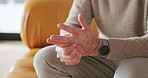 Hands, pain and senior man in home with health problem, arthritis or osteoporosis with strain. Fingers, sore and elderly person with injury, parkinson and massage for fibromyalgia relief with tension