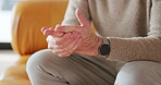 Hands, pain and senior man with arthritis, health problem and osteoporosis with strain in home. Fingers, sore and elderly person with injury, parkinson and massage for fibromyalgia with tension