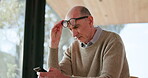Typing, glasses or elderly man in house with phone, news or chat update on social media. Digital, reading or senior person in home with tech, internet search or online communication on mobile app.