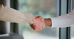 Senior, nurse and greeting with handshake for agreement, welcome or thank you in retirement home. Closeup, caregiver and shaking hands with elderly patient for assisted living, partnership or service
