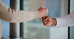Fist bump, support and nurse with old person in clinic for retirement, volunteer and trust. Assisted living, kindness and elderly care with hands of people for counseling, empathy and healthcare