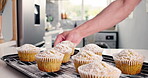 Baking, hands and icing sugar with cupcakes in kitchen of home for cooking or dessert preparation. Food, pastry and sweets with baker person in apartment for ingredients, snack or yummy recipe