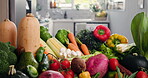 Fresh, groceries and variety with vegetables on counter in home for diet, health or nutrition. Assortment, background and vegan food with produce in kitchen of apartment for detox or weight loss
