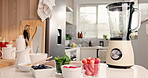 Smoothie, blender and fruit on kitchen counter for healthy drink, nutrition and natural ingredients. Series, machine and recipe with strawberry shake for gut health, fiber and antioxidant benefits.