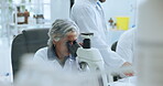 Scientist, woman and microscope analysis in lab for sample testing, genetics research or innovation. Science staff, mature person and medical equipment for pharmaceutical development and DNA study