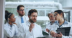 Man, scientist and team with writing on glass wall, formula and chemistry for medical research project. Person, notes and group by board for problem solving, vaccine development and pharma job at lab