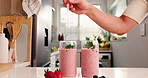 Health, straw and smoothie with hands of person in kitchen for diet, detox and nutrition. Antioxidants, breakfast and weight loss with man and drink in home for protein shake, fiber and vitamins