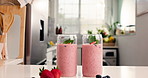 Breakfast, fruit and glass of smoothie on kitchen counter, healthy drink and detox blend for wellness. Morning nutrition, berry and mint cocktail in home for gut health, fresh and organic ingredients