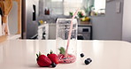 Fruit, time lapse and smoothie in glass in kitchen for diet, detox and nutrition. Antioxidants, breakfast and weight loss with strawberry drink in home for protein shake, fiber health and vitamins