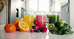 Health, fruit and glass of juice in kitchen  for detox, antioxidants and vegan drink. Wellness, nutrition and vegetables with organic liquid on table top of home for diet, breakfast and weight loss