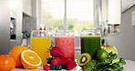 Detox, fruit and glass of juice in kitchen for health, antioxidants and vegan drink. Wellness, nutrition and vegetables with organic liquid on table top of home for diet, breakfast and weight loss