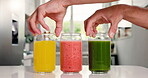 Health, juice and glass with hands in kitchen  for detox, antioxidants and vegan drink. Wellness, nutrition and fruit with organic liquid with people in home for diet, breakfast and weight loss