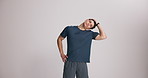 Fitness, face and man with stretching in studio to start workout, flexibility and physical activity. Mockup space, athlete and neck warm up on white background for exercise, getting ready or wellness