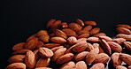 Healthy, cashew and harvest nuts in studio with natural textures, organic food and grain production. Seeds, products and roasted for supply chain, quality control and vegan snack on dark background