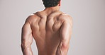 Studio, back and man flex muscle for growth, development and strength with power. Strong, shirtless person and bodybuilder with fitness progress, exercise and physique on white background space