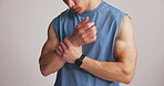 Wrist pain, fitness or athlete hands in studio, sport injury or muscle sprain from strength training. Mobility practice, joint ache or man stretching fingers, wellness or exercise on white background