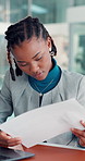 Business, black woman and reading document in office for accounting, finance report and statistics. Person, typing and financial graphs on paperwork, information and profit growth of asset management