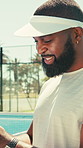 Laughing, padel and phone with black man on court for typing text message or social media post. App, fitness and sports with funny African athlete outdoor for communication, exercise or mobile update