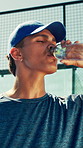 Tennis, man and drinking water at court for sports, health and wellness outdoor. Athlete, hydration and person with bottle for fitness with padel player, thirst and liquid nutrition for recovery