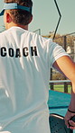 Padel, coach and hit ball on court with bat for training lesson, fitness development and sports game. Instructor, man and back with coordination exercise for tennis competition, practice and workout.