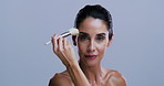 Mature woman, face and makeup brush in studio with beauty, powder and mockup space on background. Person, model and portrait with cosmetic tools for foundation, skin and application in Argentina