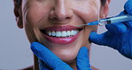 Hands, lip filler injection and happy woman in studio, plastic surgery and beauty on background. Mature person, surgeon ands smile with syringe for cosmetics, mouth or collagen for transformation