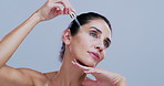 Beauty, pipette and woman in studio, cosmetics and dermatology on white background. Space, facial repair and mature person with skincare, essential oil and serum product with hyaluronic acid or shine