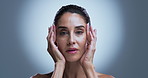 Hands, beauty and face of mature woman in studio for hydration, shine and skincare glow. Mockup space, spa and portrait of person for dermatology, facial and anti aging cosmetics on gray background