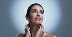 Skincare, spotlight or mature woman in studio with results, radiance or smooth skin in antiaging treatment. Dermatology, space or girl on gray background with confidence, shine or glow in body care.