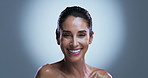Face, smile and woman in studio, skincare and shine with dermatology on gray background. Space, beauty and mature person with cosmetics, glow or grooming with healthy skin, anti aging or aesthetic