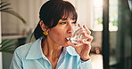 Woman, drinking water and tablet in home for wellness, pharma drugs and supplement in morning. Mature person, glass and medicine with benefits for brain function, healthcare and pills at apartment