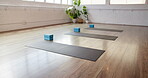 Fitness, start and mat in gym on floor, preparation and equipment for body wellness class. Yoga, empty room and setup in studio with support blocks, workout group or beginning of pilates training.