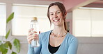 Face, yoga and instructor with water bottle in studio for fitness training, hydration or wellness practice. Portrait, happy woman or holistic coach with liquid, refreshing drink or workout for health