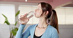 Woman, exercise and yoga with water for hydration, recovery or natural beverage in gym. Female person, yogi or thirst with aqua, mineral liquid or bottle for break, rest or drink in health club