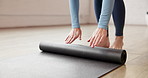 Yoga mat, rolling and woman in studio, meditation and balance with wellness, exercise and stress relief. Person, fitness and health club with break, energy and start with workout and inner peace