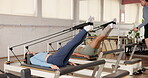 Pilates, instructor and reformer machine with women in studio for core, workout and resistance bands. Equipment, wellness club and lesson with people in fitness class for balance, exercise and health