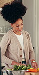 Cooking, cutting and vegetables with woman in kitchen of home for online culinary class or recipe. App, healthy ingredients and instructions with person in apartment for diet, health or nutrition