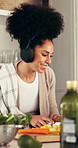 Dancing, woman and cooking with headphones in home for music playlist, meal prep or healthy food. Energy, happy person and listening to radio with cutting vegetables, dinner recipe or feel good sound
