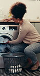 Kitchen, washing machine and woman with clothes, chores and laundry in apartment and spring cleaning. Sanitary, routine and loading fabric in electrical appliance, African person and hygiene in house