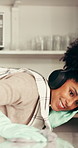 Headphones, cleaning and woman wipe kitchen counter for hygiene maintenance, housework or sanitation. Music, chores and happy African person dance, table disinfection and listening to radio in home