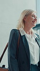Walking, greeting and mature woman in office with smile, entry and motivated for start of day. Welcome, happy and female manager in workplace lobby with confidence, ambitious and friendly in morning.