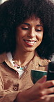 Coffee, woman and happy with phone in home for internet browsing, social media post or weekend break. Relax, person and drinking tea with smartphone in house for mobile chat or reading online comment