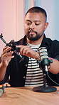 Man, podcast and review at recording studio with drone, tech and product test for web show. Person, speaker and influencer with microphone, explain and content creation with discussion on live stream