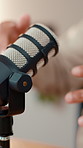 Influencer, hands and talking with mic for podcast, audio broadcast or news channel in home. Closeup, content creator or guest speaker with remote work for explaining online business on microphone
