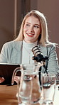 Mic, woman and talk show with tablet in studio for online interview, radio platform or questions. Live broadcast, presenter and podcast with tech on air for public relations, media production or chat
