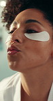 Beauty, eye mask and kiss with woman in bathroom of home for cosmetic or skincare routine. Antiaging, dermatology product and lips with smile of happy person in apartment for facial treatment