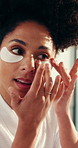 Application, beauty and eye mask with woman in bathroom of home for cosmetic or skincare routine. Antiaging, dermatology product and pads with smile of happy person in apartment for facial treatment