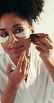 Beauty, eye mask and gua sha with woman in bathroom of home for cosmetic or skincare routine. Antiaging, dermatology product and massage with smile of happy person in apartment for facial treatment